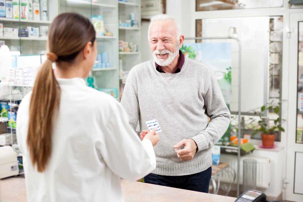 Pharmacist speaking to an older patient